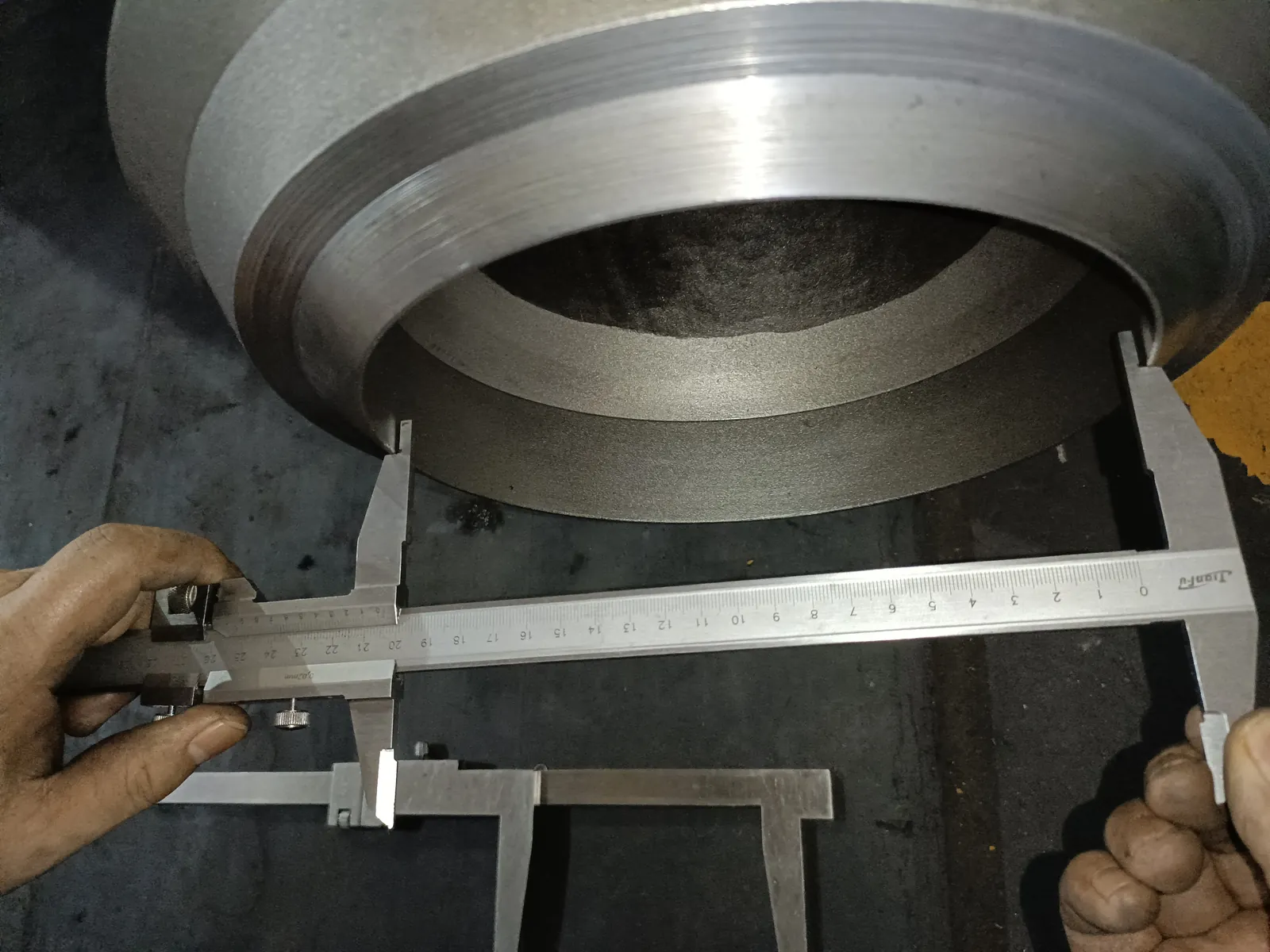 Vernier caliper measuring the weld end bore of the same check valve