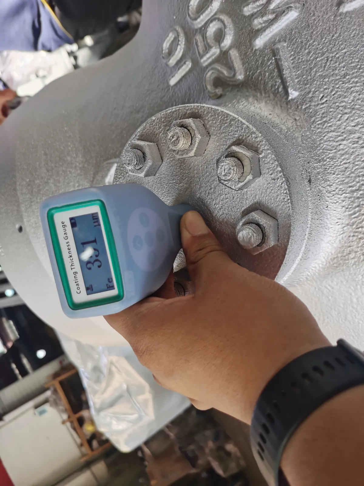Dry film thickness gauge being used on the painted valve body