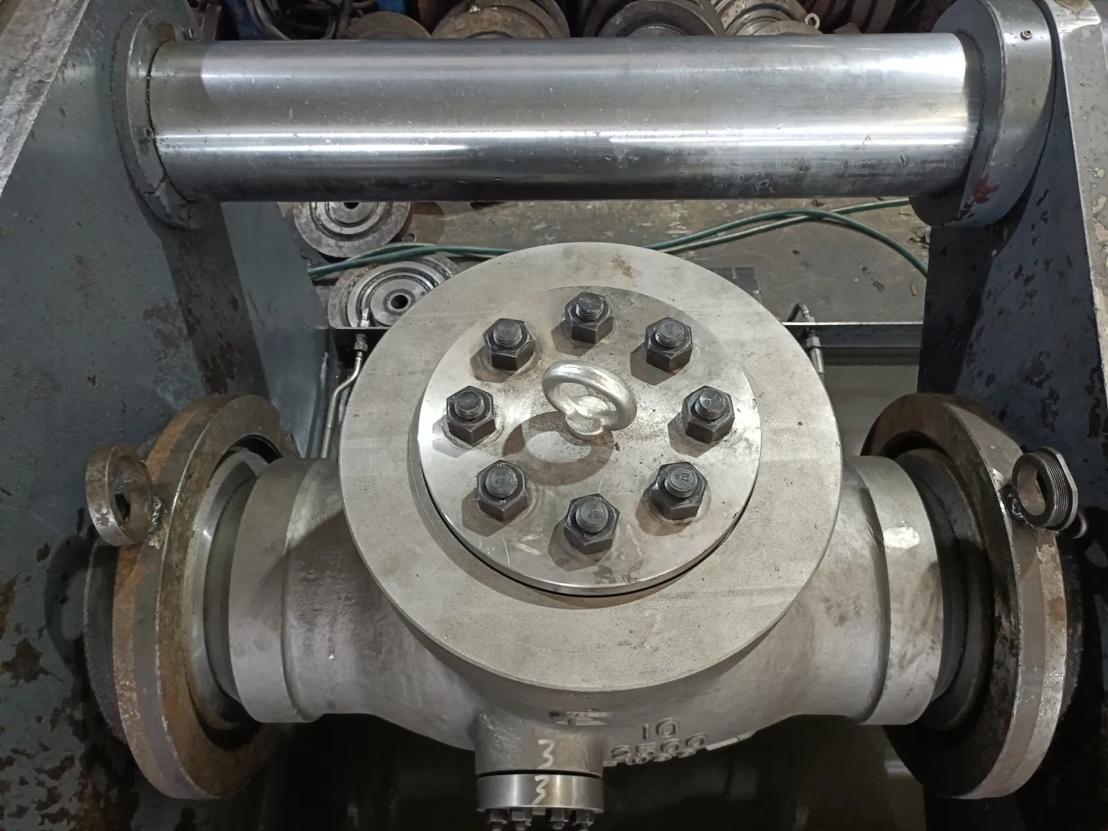 Valve clamped between the test rig platens with end blanks fitted